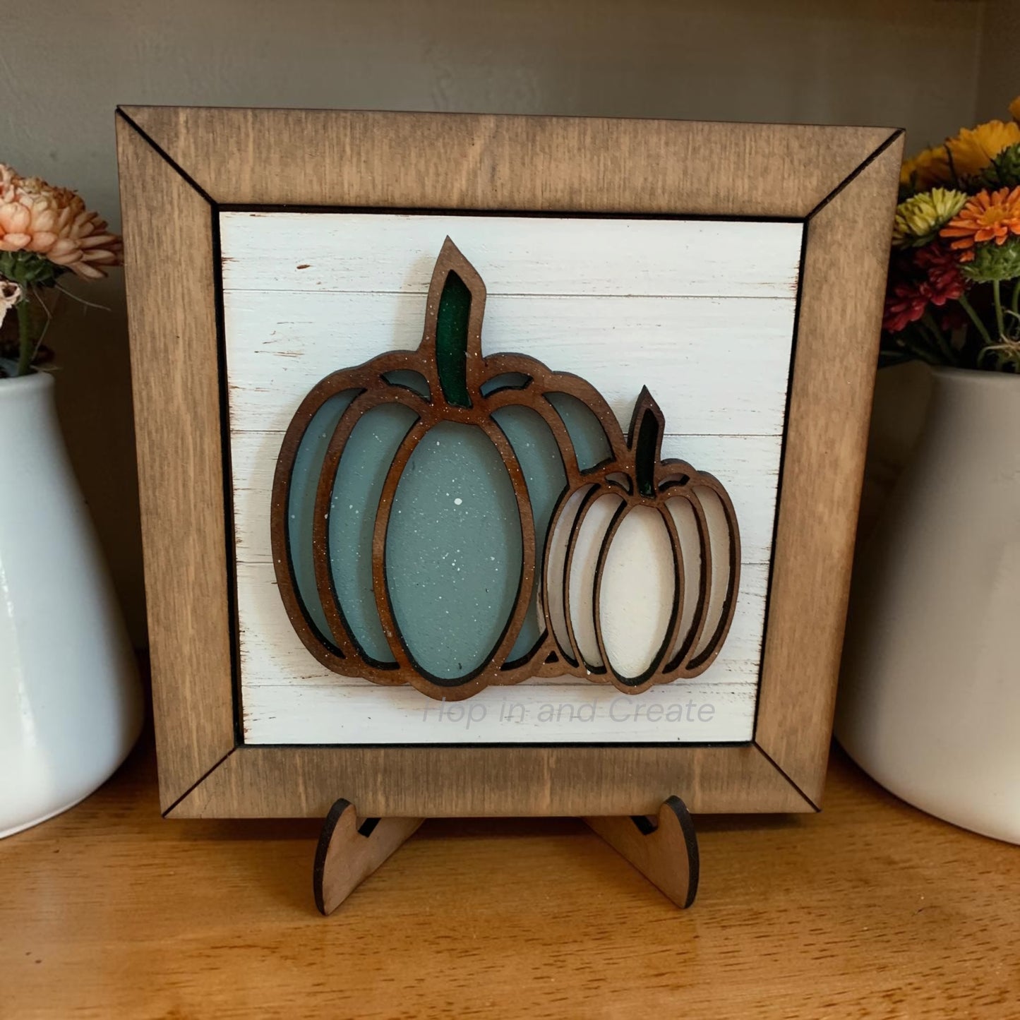 Wooden framed decorative sign with pumpkins on a white background