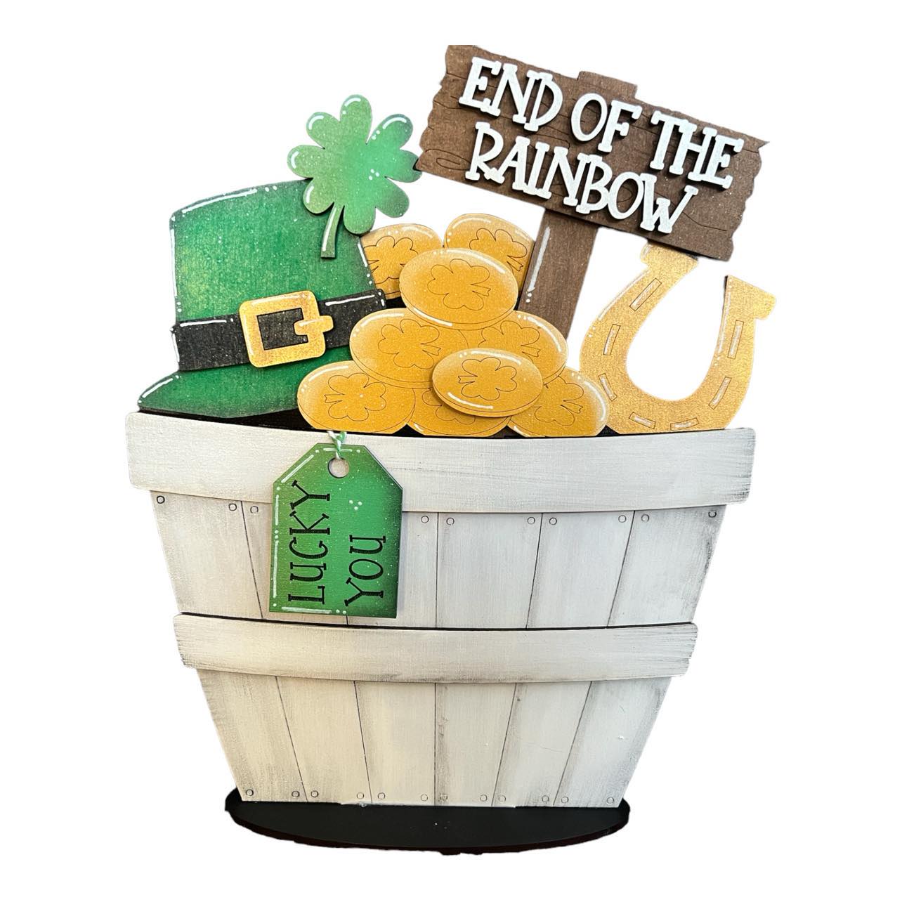 A St. Patrick's Day themed basket insert featuring a green hat, gold coins, a horseshoe, and a sign reading 'End of the Rainbow'.