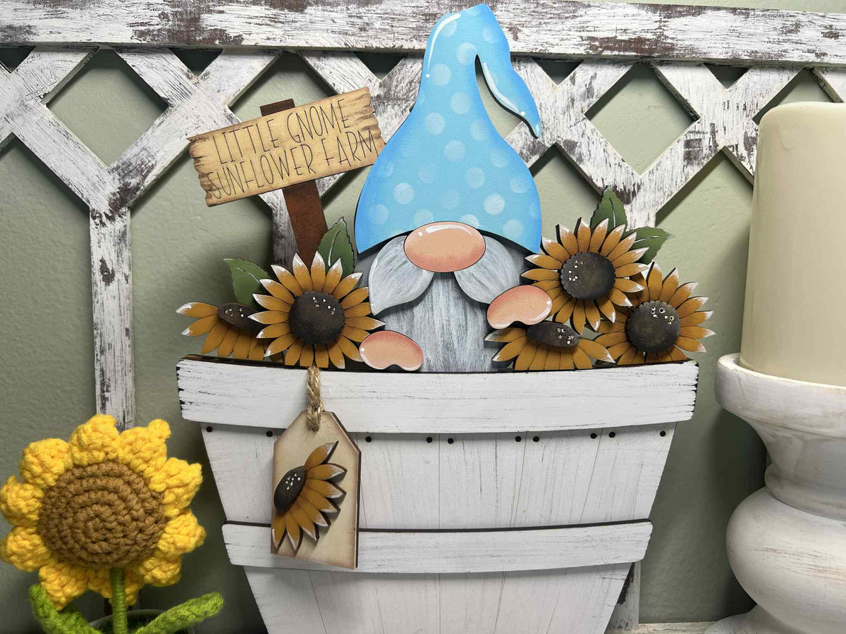 Decorative gnome with sunflowers and a sign on a wooden lattice background