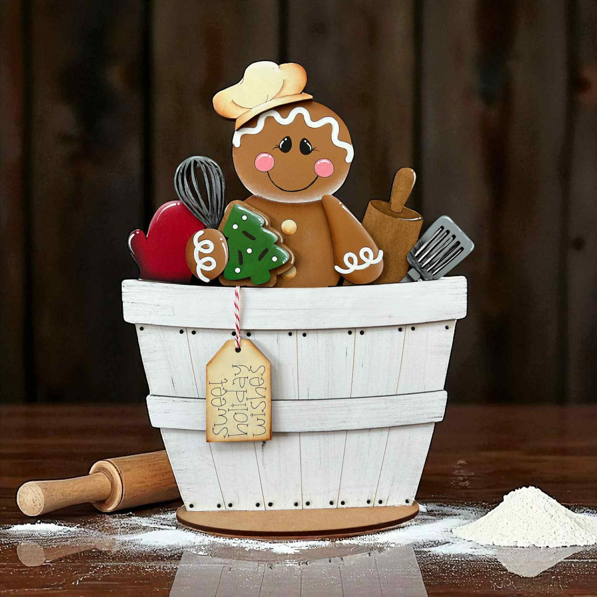 Gingerbread man decoration in a white basket with baking tools 