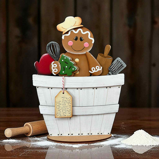 Gingerbread man decoration in a white basket with baking tools 