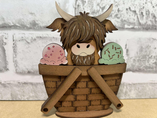 A decorative basket insert with a highland cow and ice cream design.